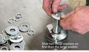 Slide 2 small washers on first then the larger washer